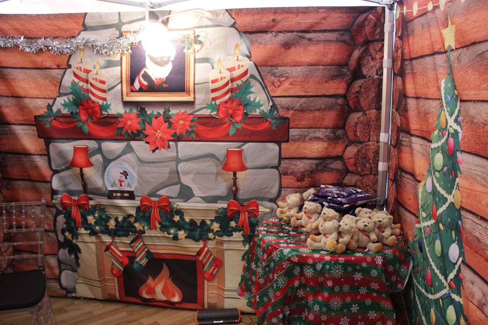 Festive branded stall serving customers at a winter event