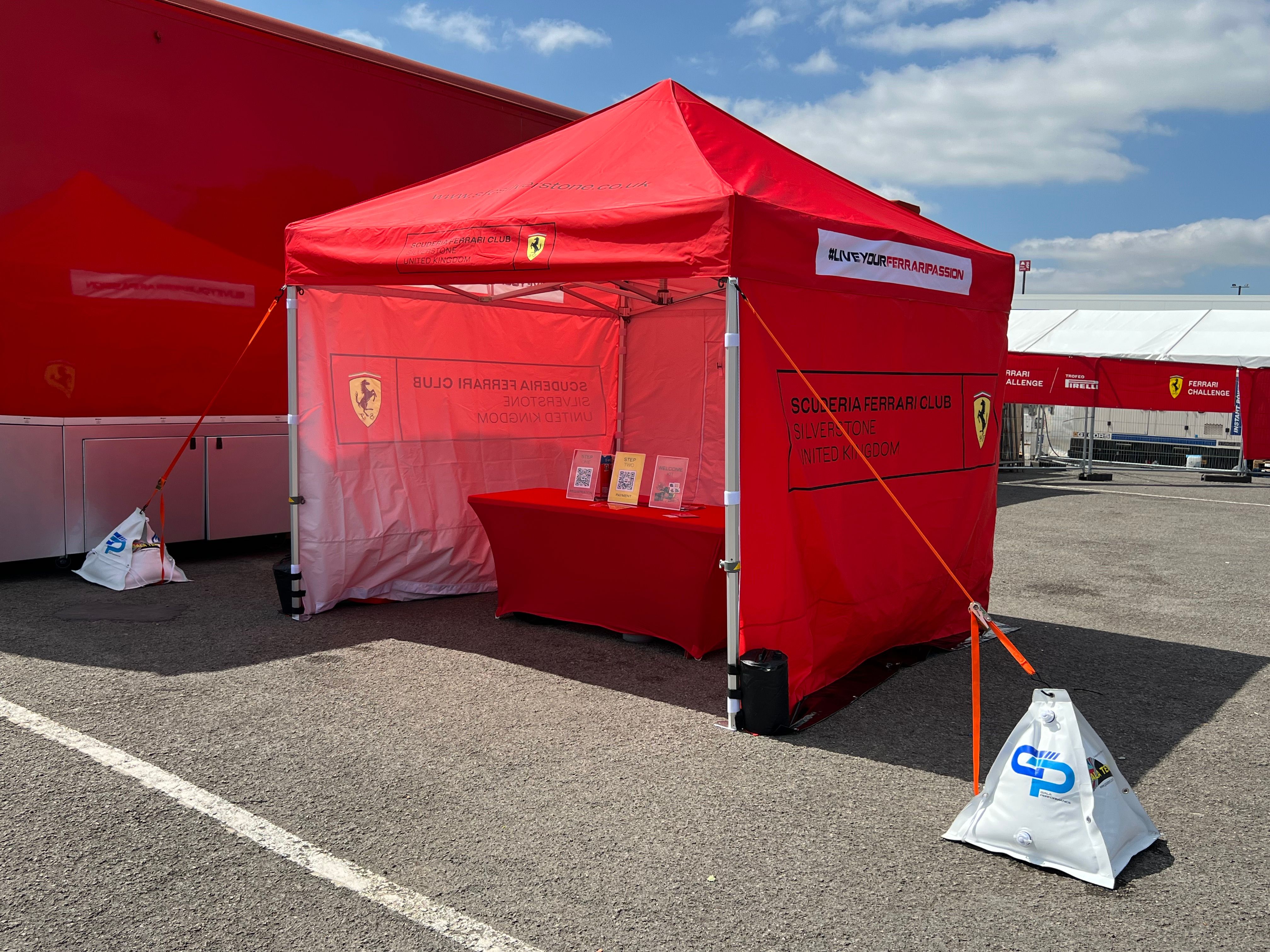 Race gazebo being cleaned and maintained in a motorsport paddock