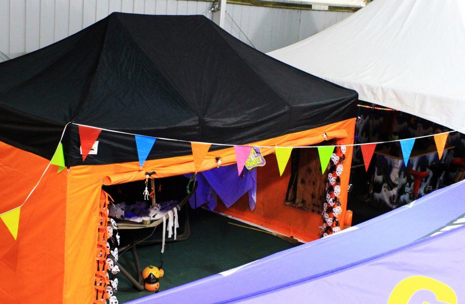 Branded feather flags marking a stand on an event trail