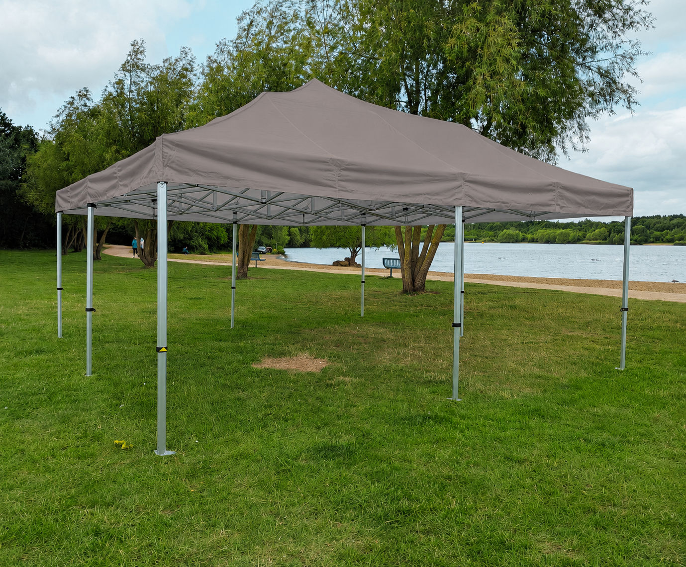 A taupe gazebo beside a lake