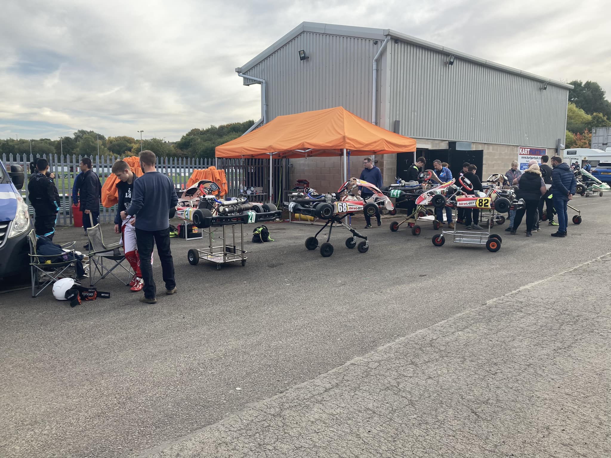Karting club paddock with awnings and karts on trolleys