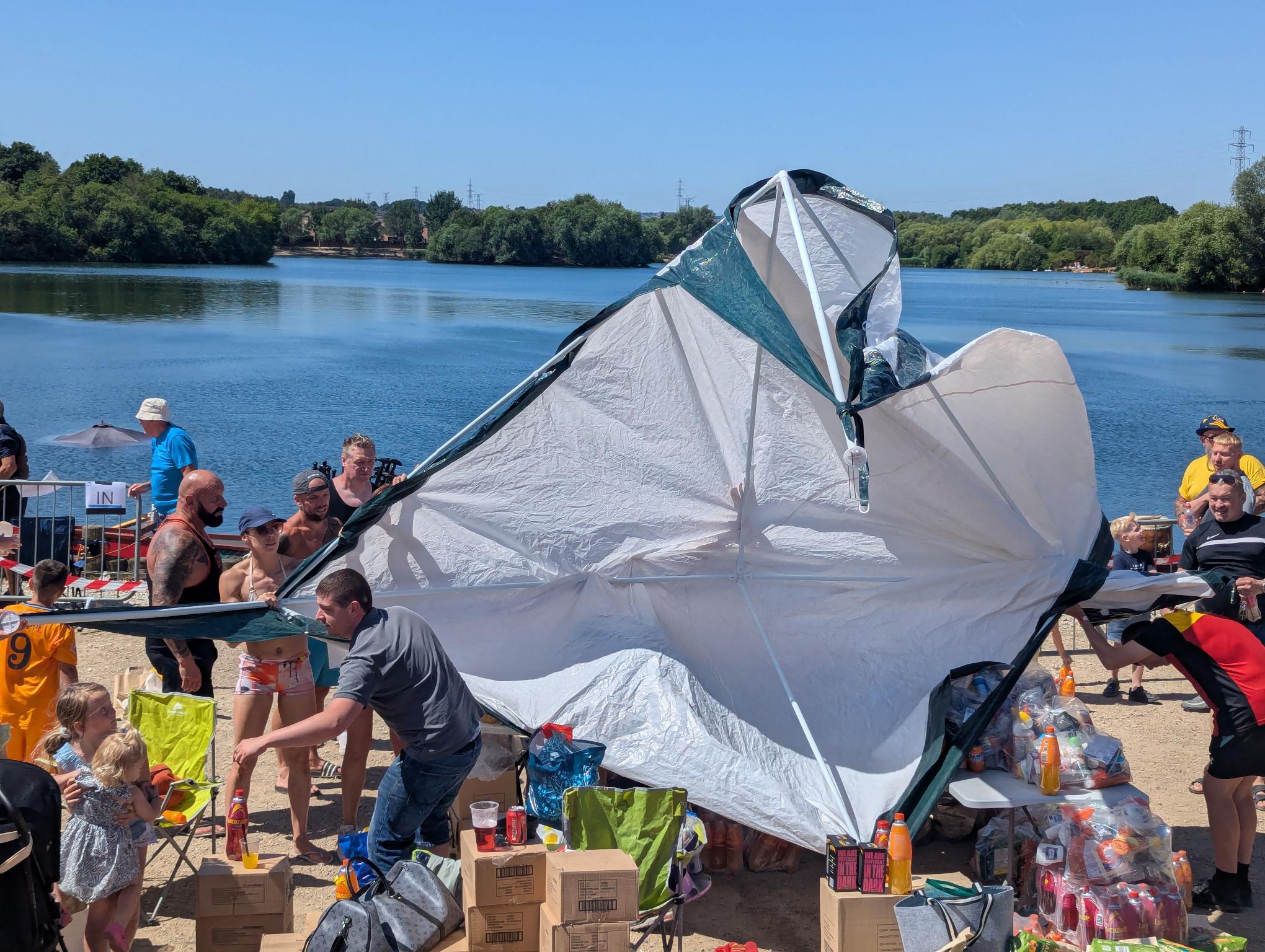 A broken cheap marquee by a lake collapsed