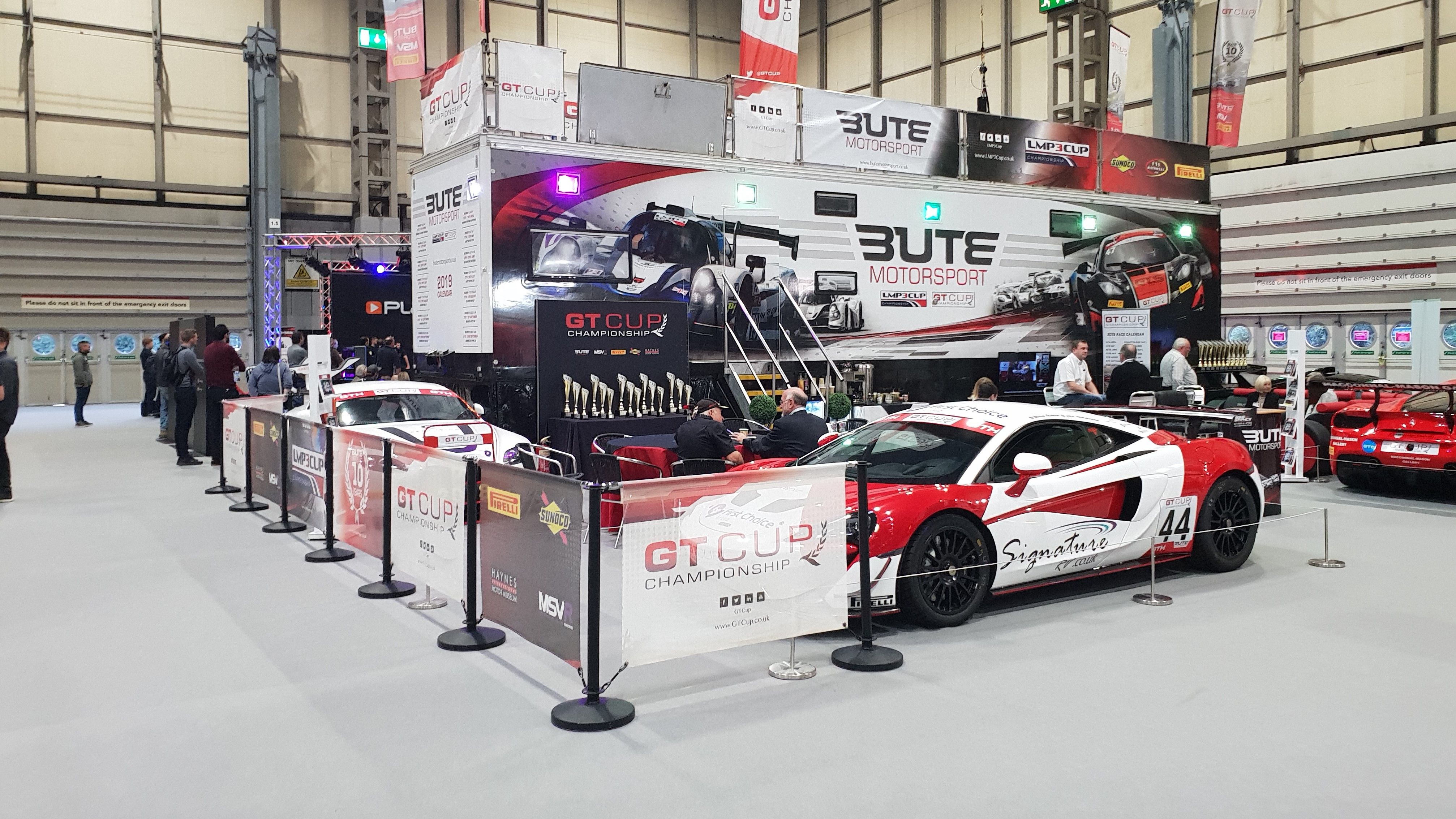 Trade exhibition space with cafe barriers around the perimeter