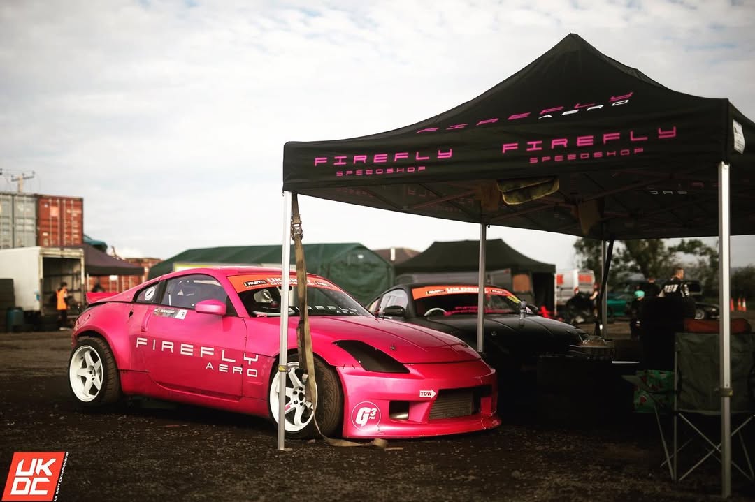 Drift cars lined up in the paddock at a competition event
