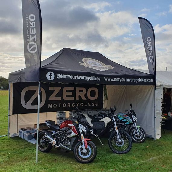 Motorbikes parked inside a heavy duty pop up gazebo, protected from the elements