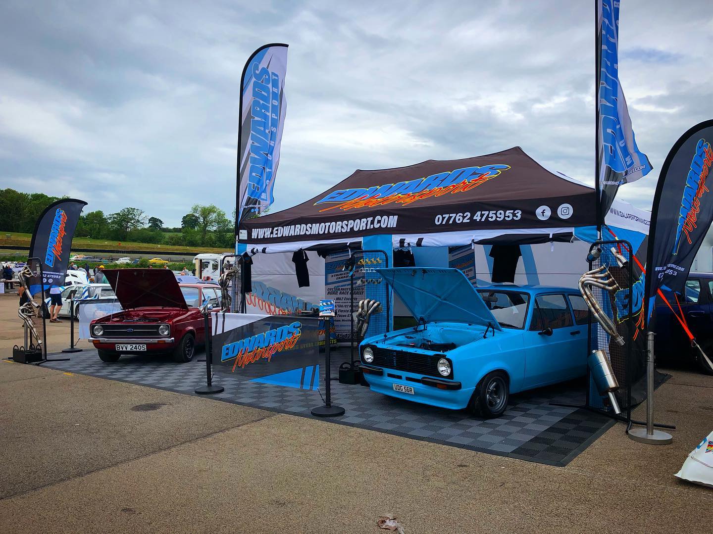 Printed 3m x 6m gazebo with two branded sail flags at an outdoor event