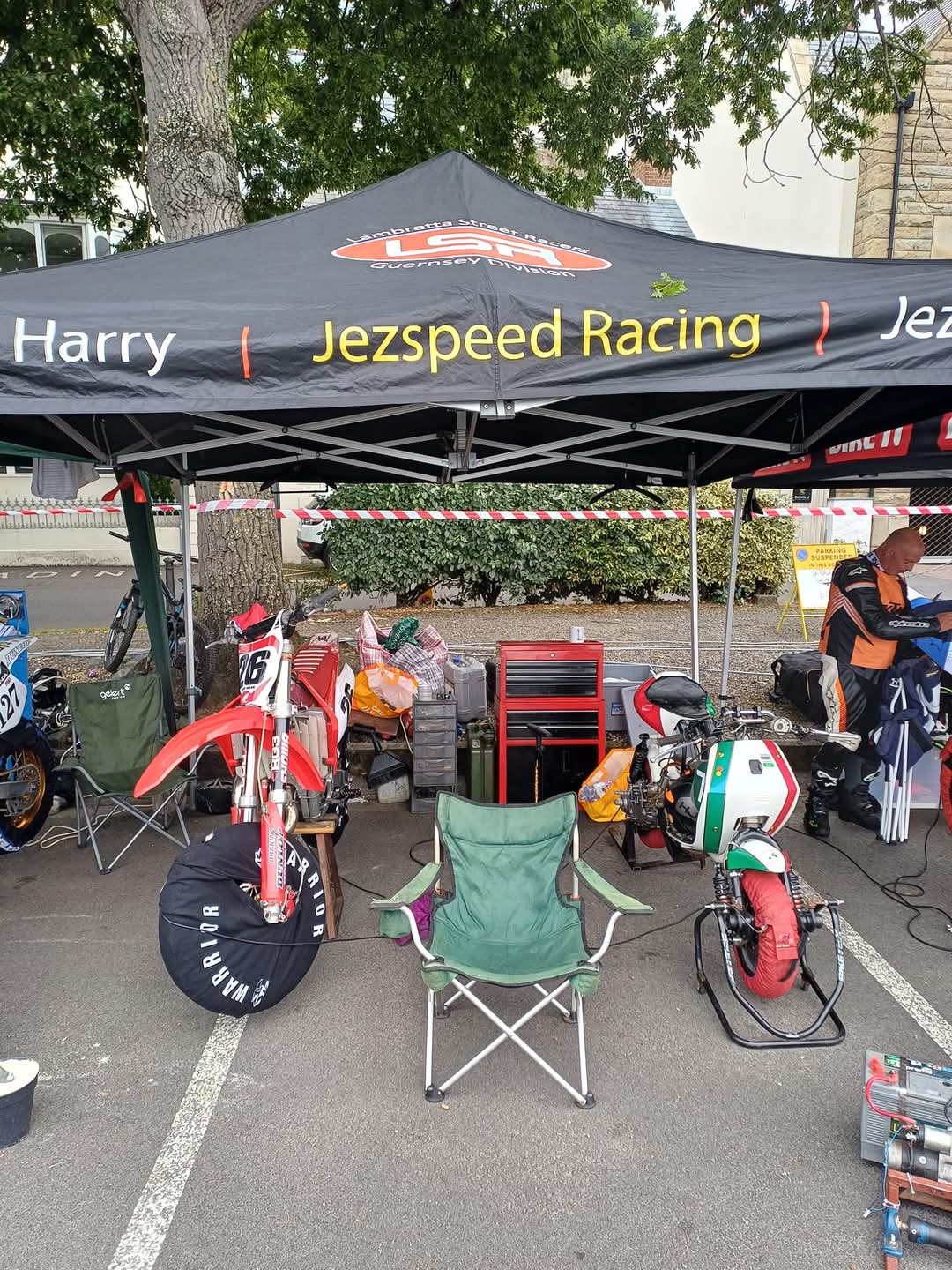 Motocross pit gazebo with dirt bike and tools