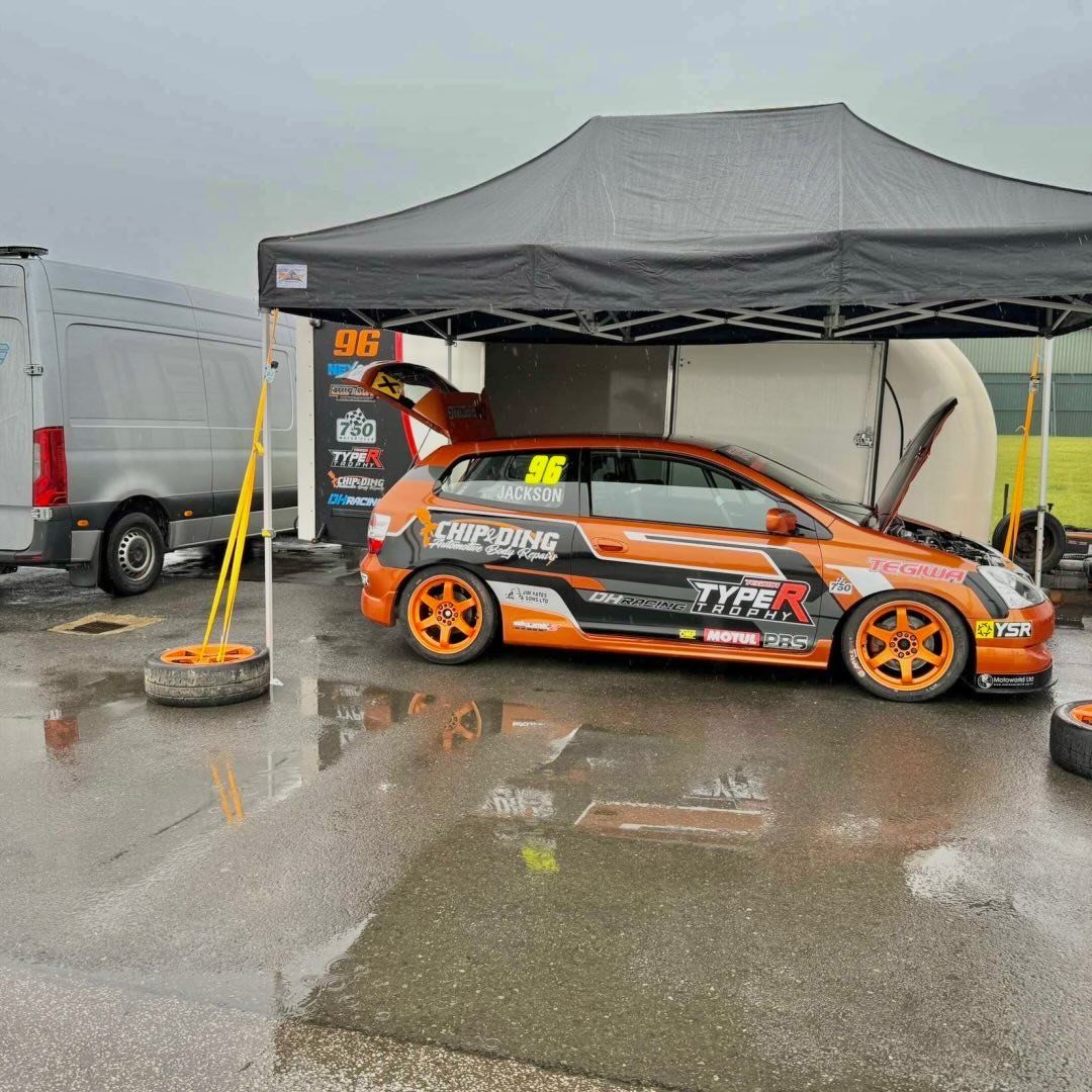 Competitor sheltering under an awning between runs at a speed event