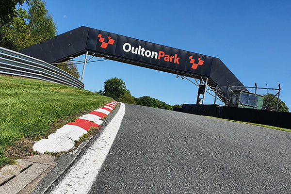 Race car through the parkland at Oulton Park