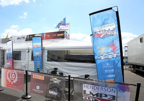 Printed flags outside a motorsport hospitality unit