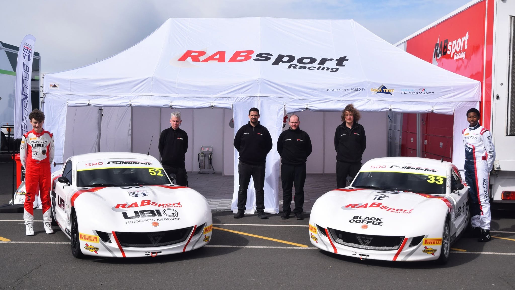 Race team working under a motorsport tent
