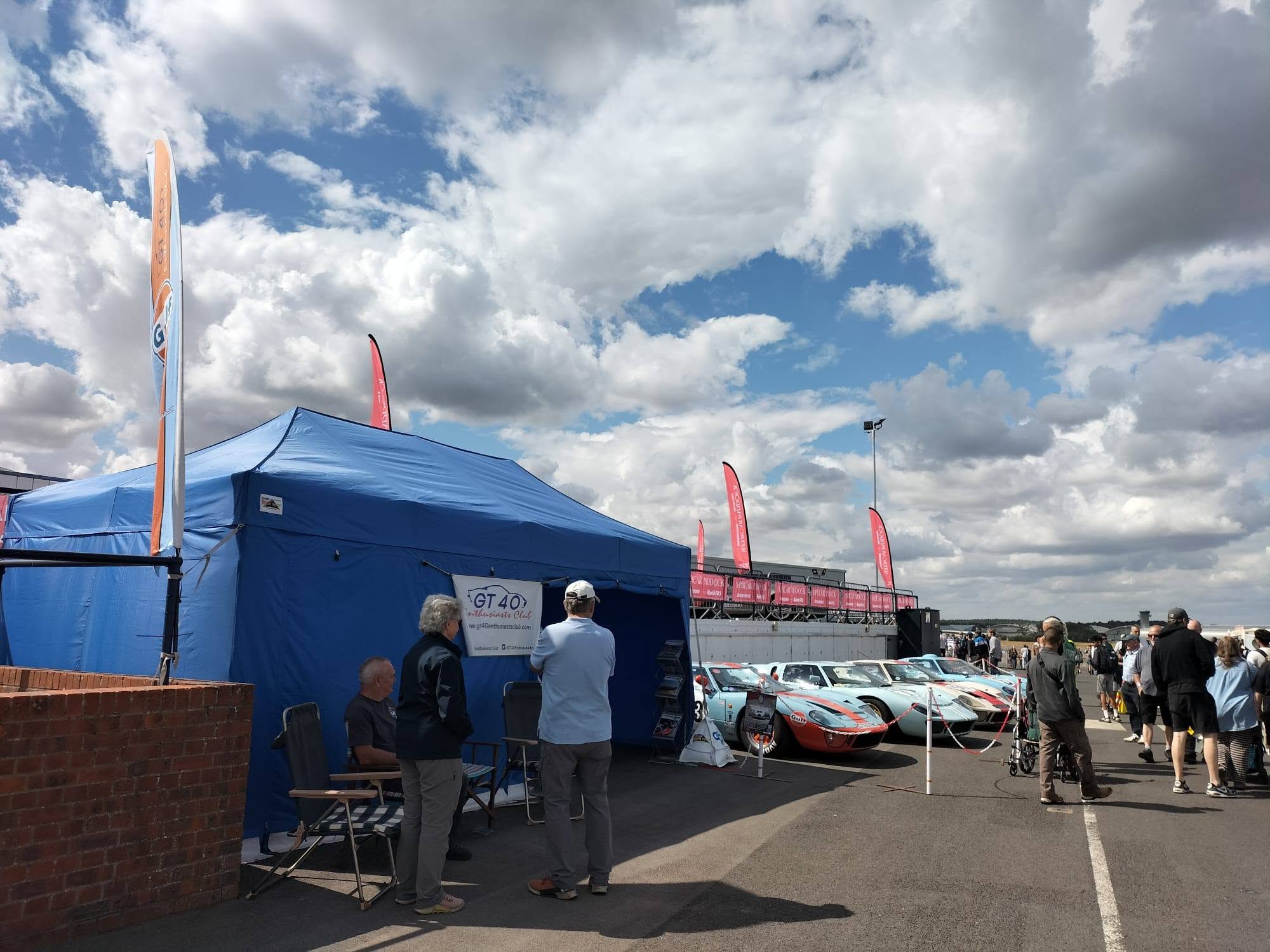 Pop up awning anchored with weights in a kart paddock