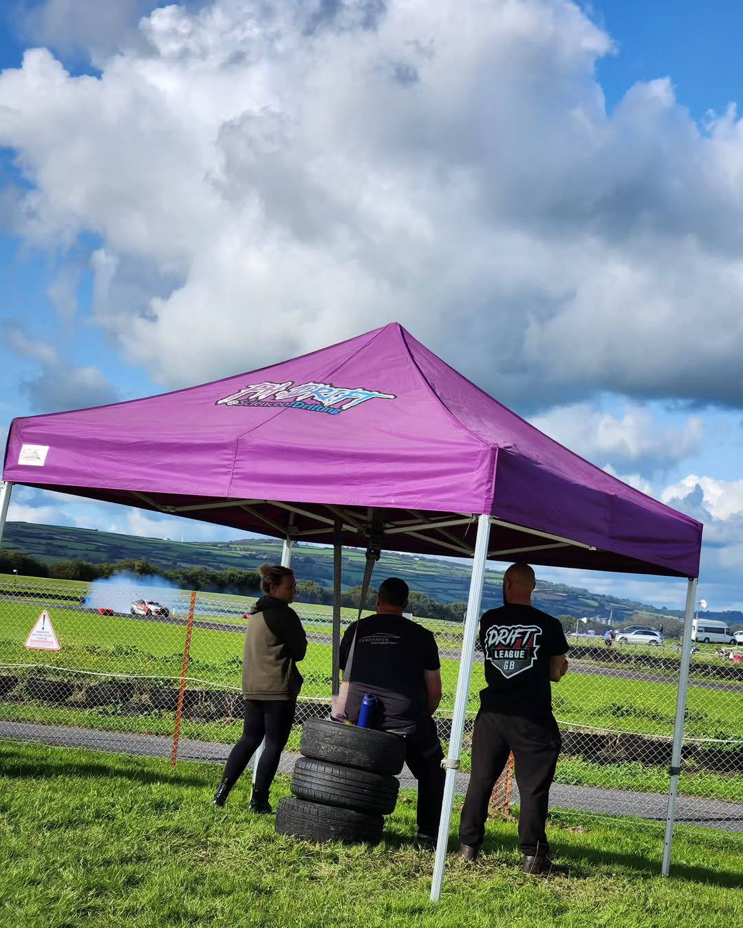 Pop up awning pegged and weighted on grass at a hillclimb