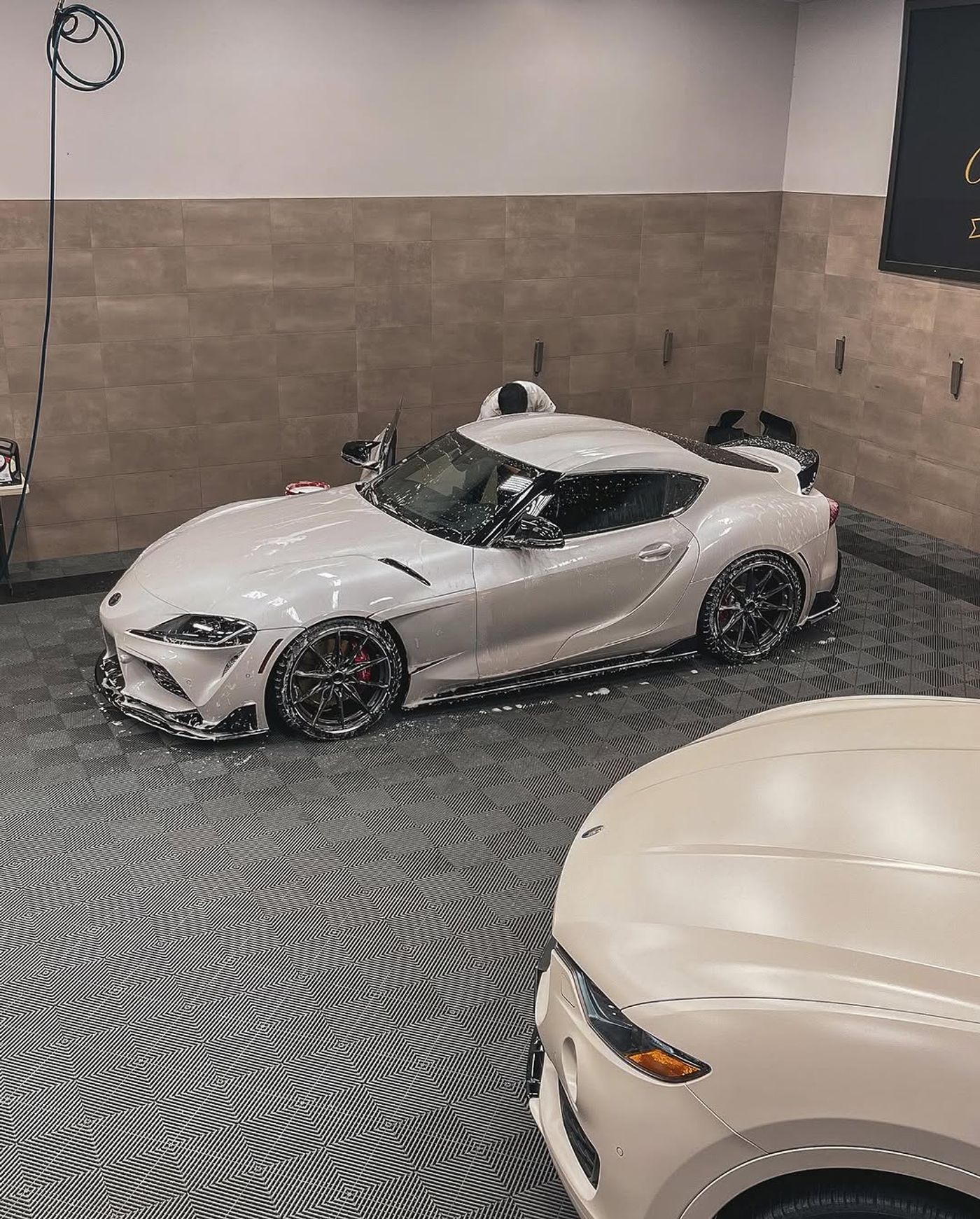 Toyota Supra parked on a grey Swisstrax Ribtrax floor