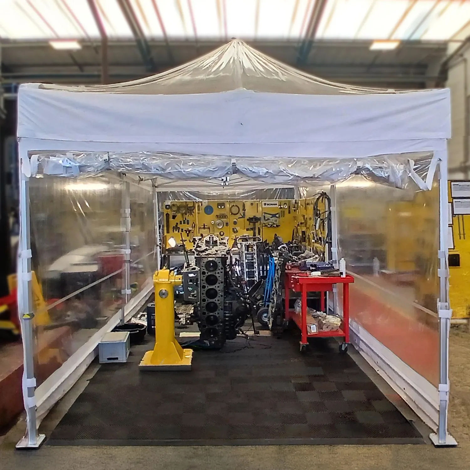 clear gazebo with transparent sides in engine workshop