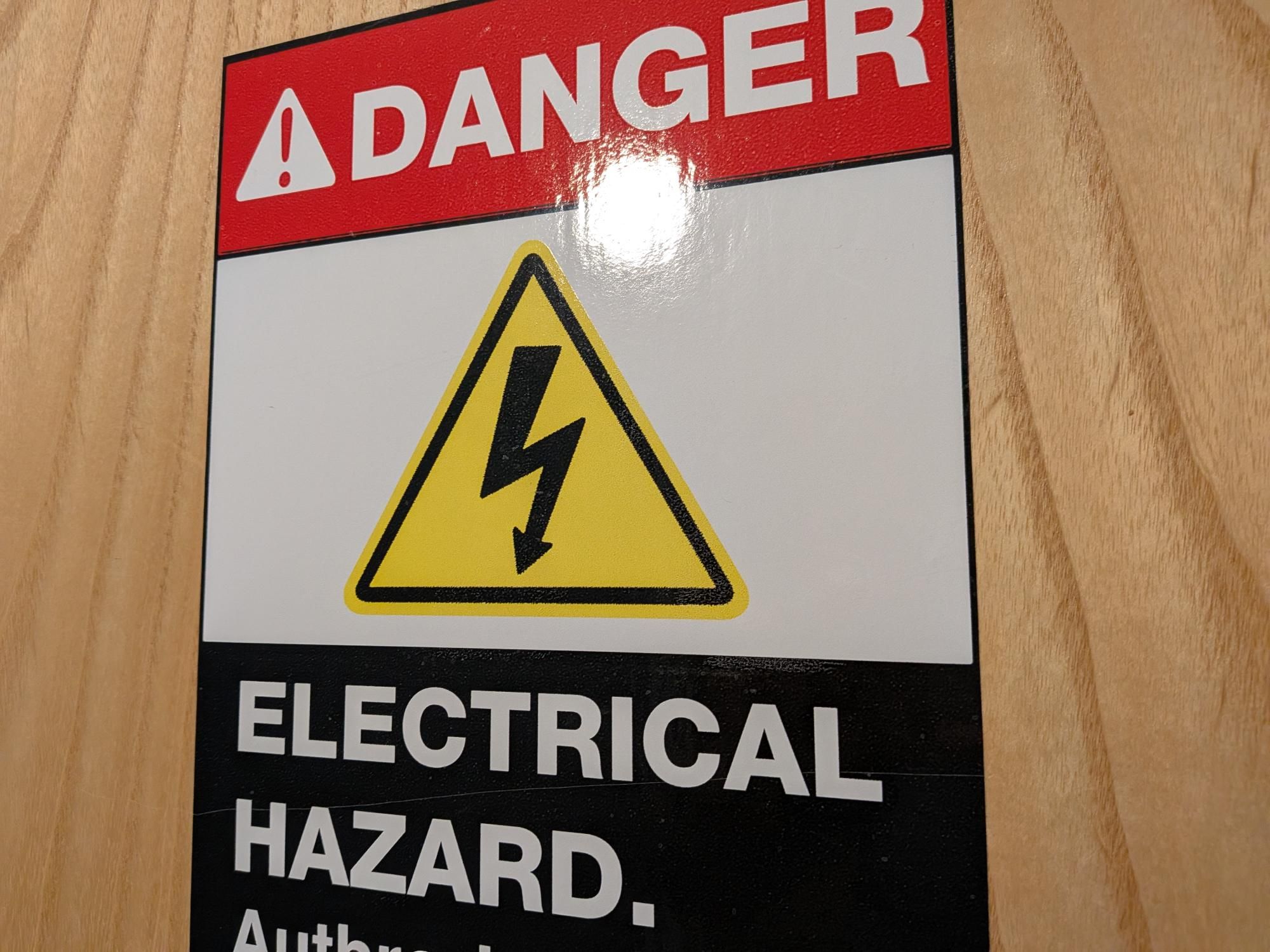 door sign highlighting electrical danger